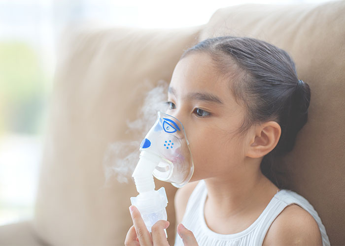 Image of young girl using respiratory equipment